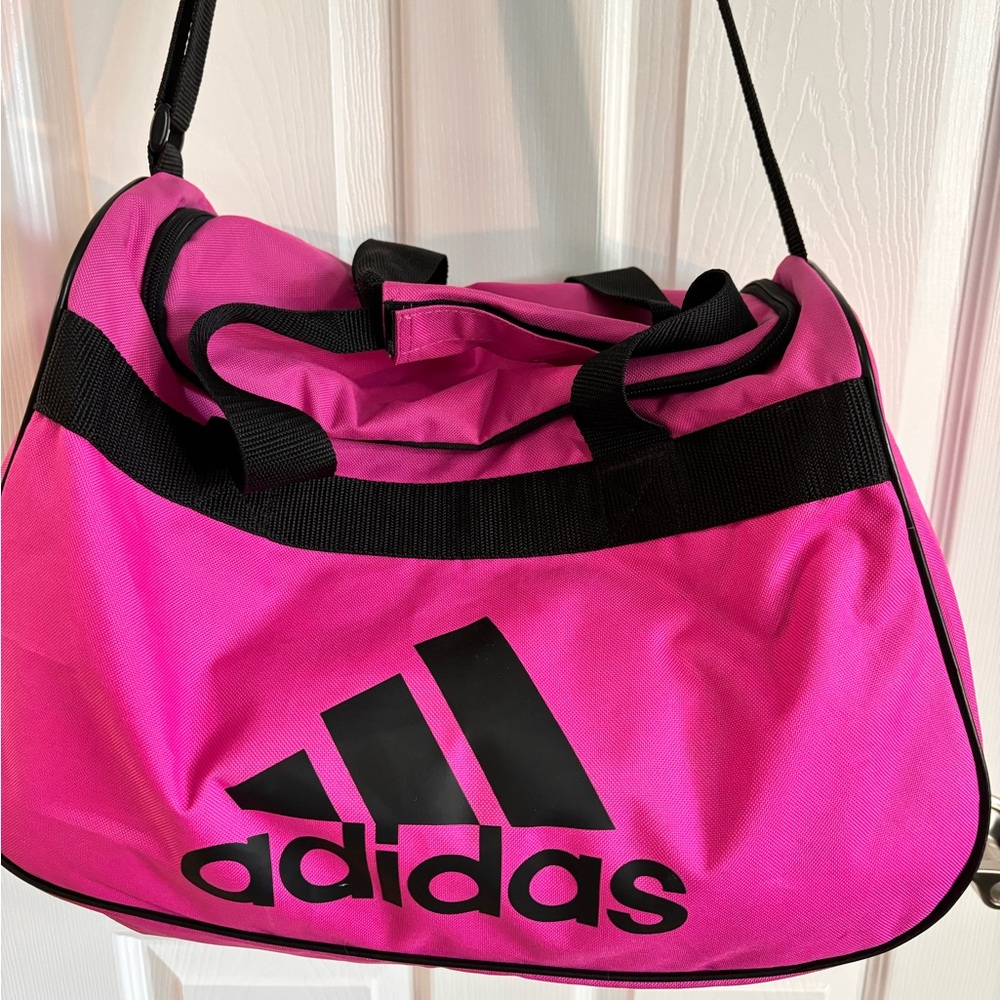 Adidas bright pink duffel bag. Small but very roomy for all your gym clothes.